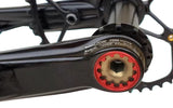 Close-up of a bicycle crankset with a focus on the gear and chain area.